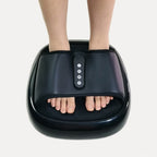 Compact heated foot massager with textured footbed and digital control panel in a modern home setting.