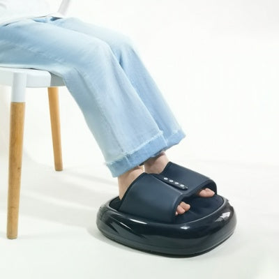 Compact heated foot massager with textured footbed and digital control panel in a modern home setting.