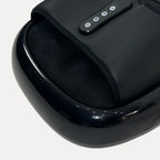 Compact heated foot massager with textured footbed and digital control panel in a modern home setting.