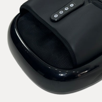 Compact heated foot massager with textured footbed and digital control panel in a modern home setting.