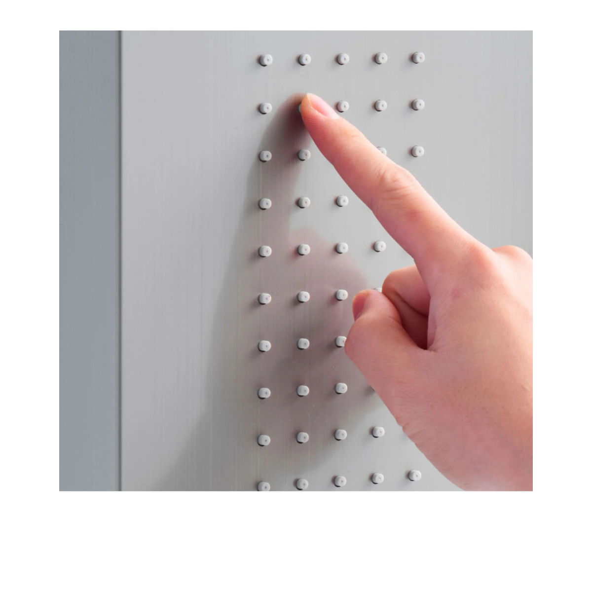 Macro detail of Aurora V Luxe anti-clog silicone nozzles on a 304 stainless steel panel showing premium architectural craftsmanship.